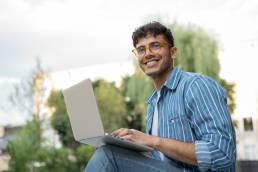 handsome-copywriter-using-laptop-computer